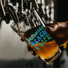 Load image into Gallery viewer, Delaware_Beach_Life_4_Eva_Pint_Glass_Pint_Glass_Dark_Lifestyle_Mockup.png
