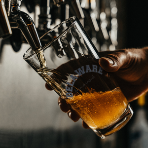 Delaware_Born_and_Raised_Pint_Glass_Pint_Glass_Dark_Lifestyle_Mockup.png
