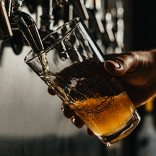 Load image into Gallery viewer, Lets_Bethany_It_Pint_Glass_Pint_Glass_Dark_Lifestyle_Mockup.png

