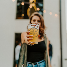 Load image into Gallery viewer, Lets_Bethany_It_Pint_Glass_Pint_Glass_Model_Lifestyle_Mockup.png

