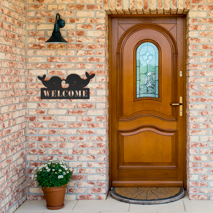 Whale_Welcome_Metal_Sign_Black_Brick_Entrance_Mockup.png